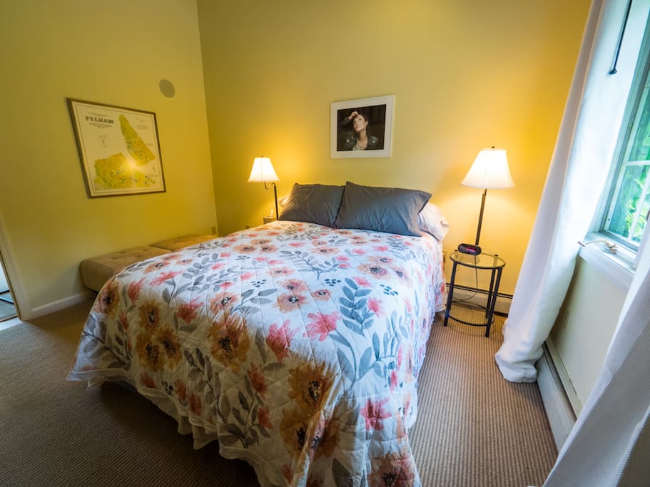 Bedroom with ample sunlight and cathedral ceiling.