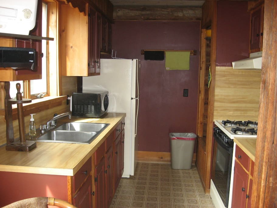 Kitchen with full size stove, refrig, microwave, coffee maker