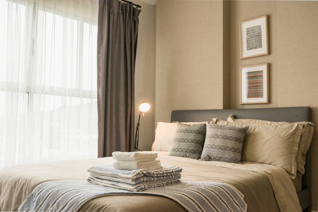 The Bed is neatly prepared with towels provided