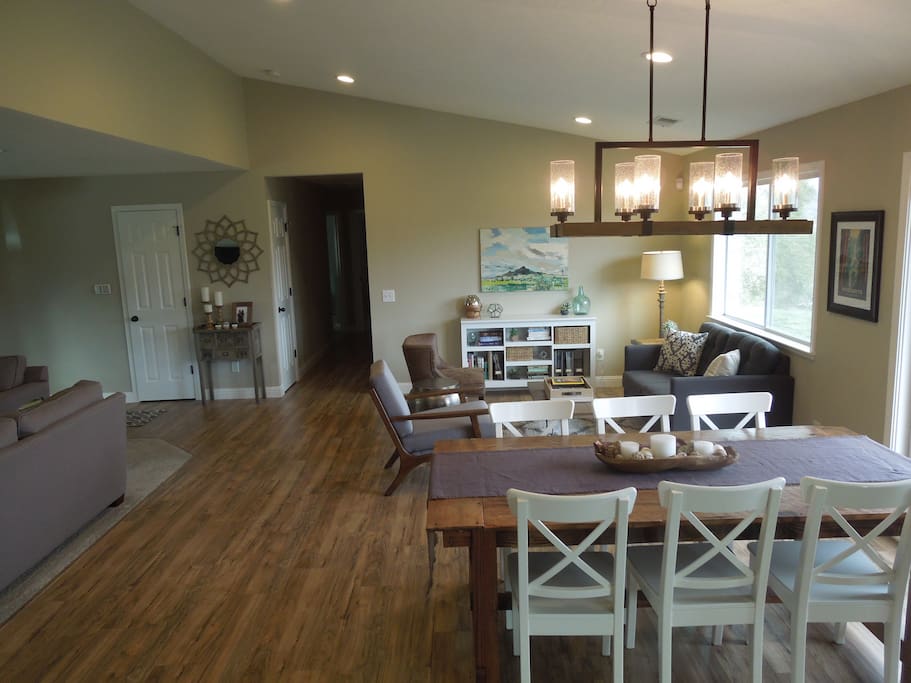 The front room has an open floor plan which includes the living room, dining areas, kitchen, and reading nook. Large windows and french doors provide beautiful views from every angle.