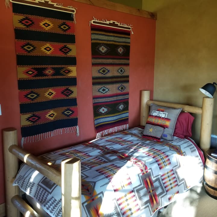 Twin bed has 3/4 wall, 2 beds in room,
ensuite 1/2 bath. Has a large ceiling fan with remote controlled operation. It's moderately open at the ceiling & side to the family room but still offers plenty of privacy.  