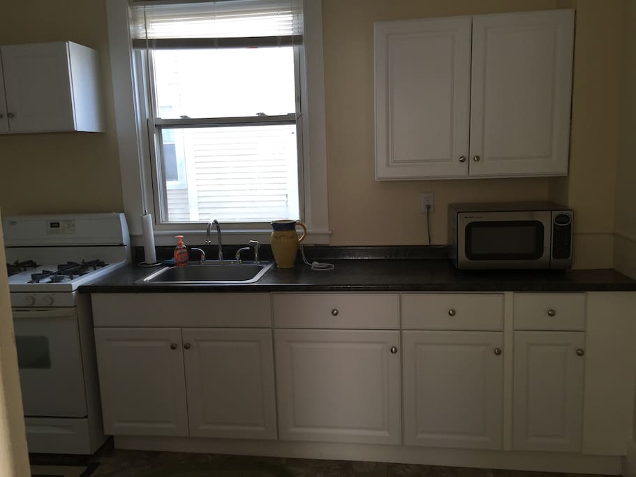Gas stove, microwave, toaster fridge/freezer with all items to cook a home cooked meal