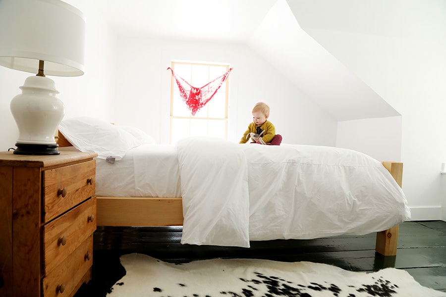 Another corner bedroom featuring a Vermont made timber frame bed. The house is a perfect place for children and families to gather.