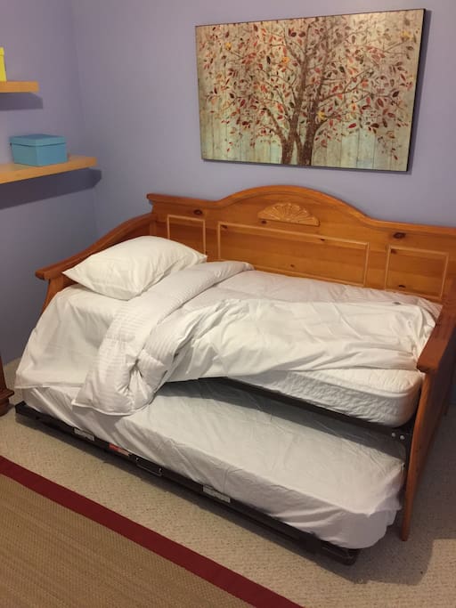The bed is a high-rise with an additional pull-out mattress underneath for a second guest .