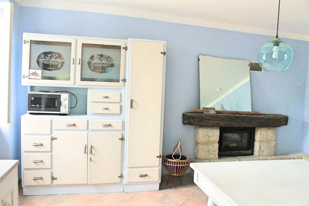 Mobile vintage nella grande cucina blu. Vintage furniture in the big blue kitchen.