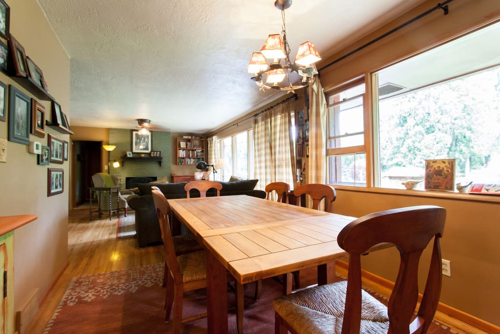 Dining room looking into living room and wall of windows overlooking urban farm.