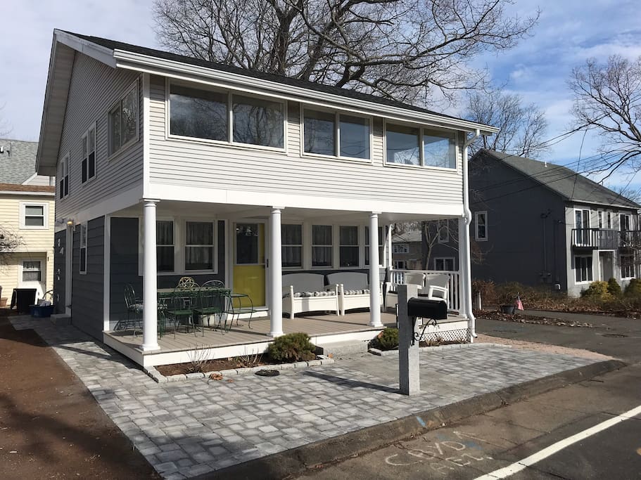 Outside dining on front porch and outside shower with hot and cold water on left side of house to quickly wash off after a fun day at the beach.