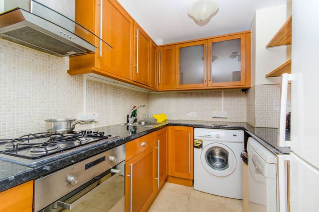 Kitchen with washing machine and dishwasher.