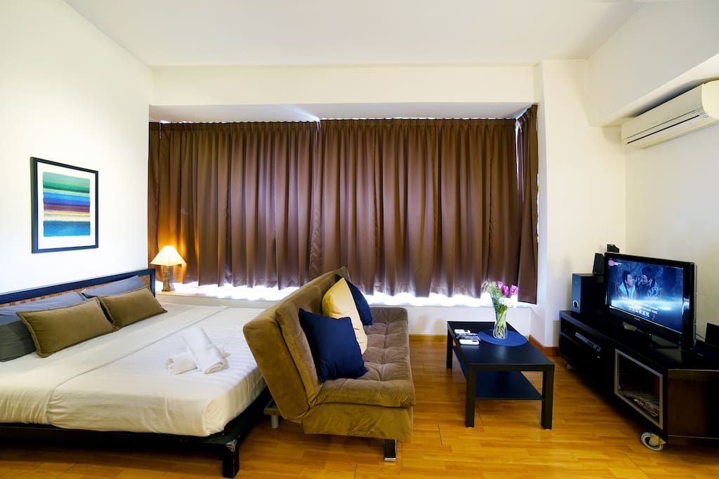 Modern Interior Design Suites Room with Queen size bed with quality linens and towels.