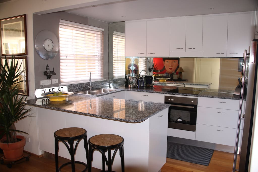 Kitchen with stainless appliances and granite bench tops.