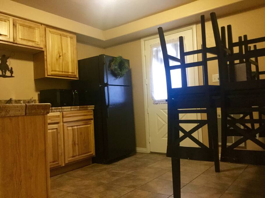 Kitchen (includes fridge, microwave, table, oven, coffee maker, toaster, electric can opener, pots/pans, and dishes).
