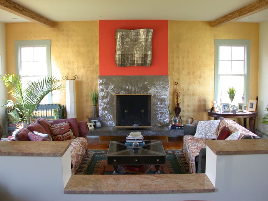 Cozy, elegant, art appointed living room. Two steps down.French doors on both sides.