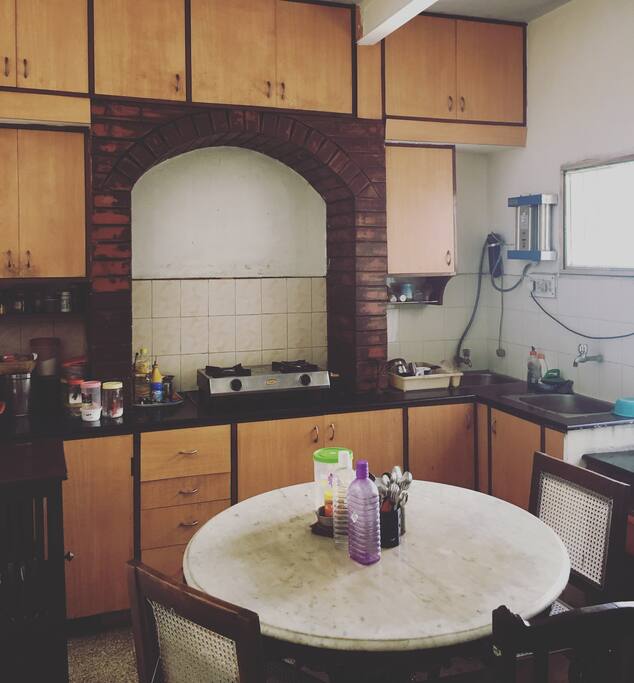 Kitchen with Dining Table, Fridge, Stove and other necessary Amenities
