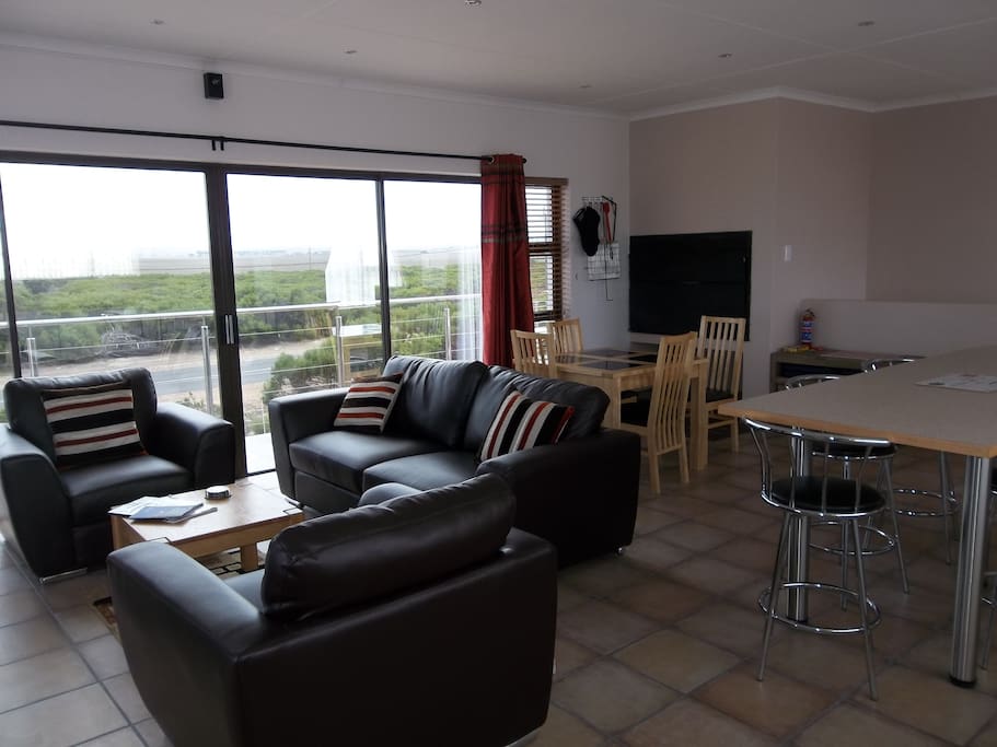Open plan lounge, dining and kitchen with built-in braai