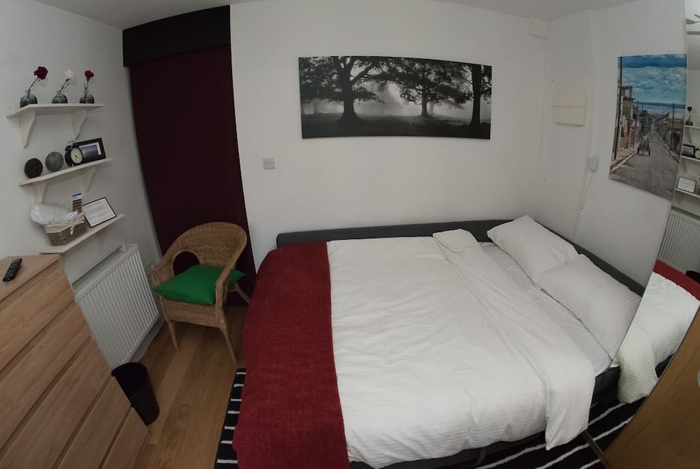 Space made up as Sleeping area: radiator, pullout double bed, chest of draws (stocked with extra set of bed linen), 24" Freeview TV, mirrored wardrobe (with safe deposit box)