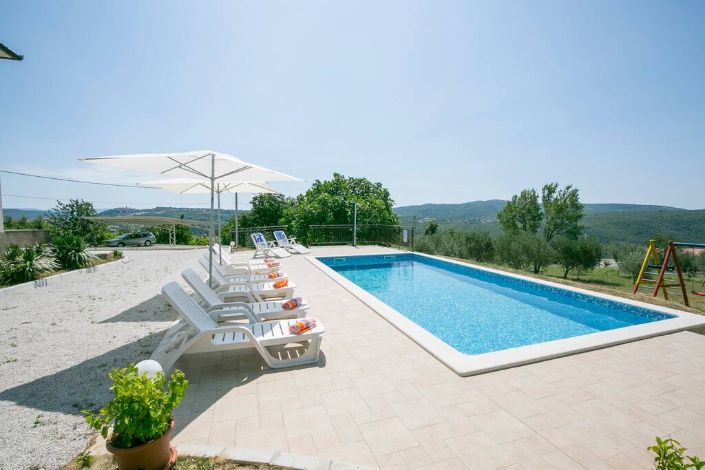 Swimming pool and sun loungers