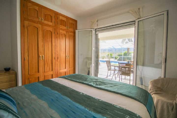 Bedroom Nr. 2 with a double bed, built-in wardrobe, door leading to the fly-free terrace.