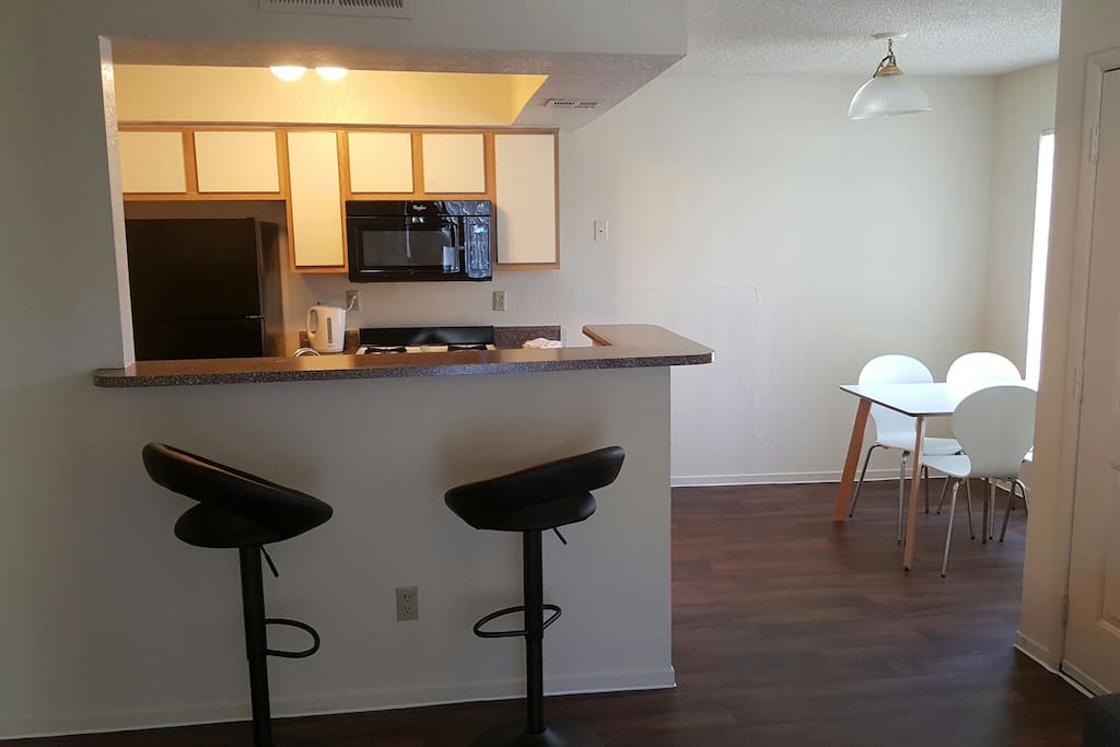 Cozy Kitchen with Breakfast Counter, and 4 seat table.