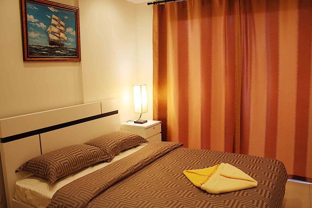 Spacious bed with latex pillows and satin sheets.
