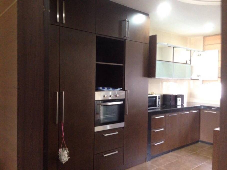 Built in kitchen cabinets with stove, oven and microwave