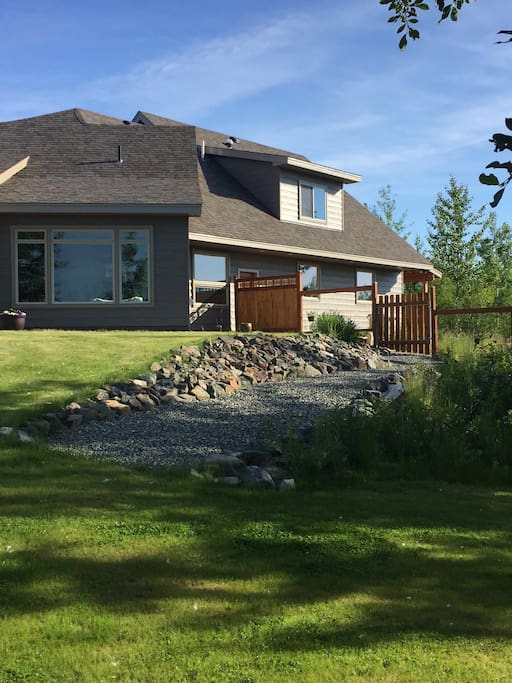 Rental Apartment has privacy gate and gravel path leading to yard and lake