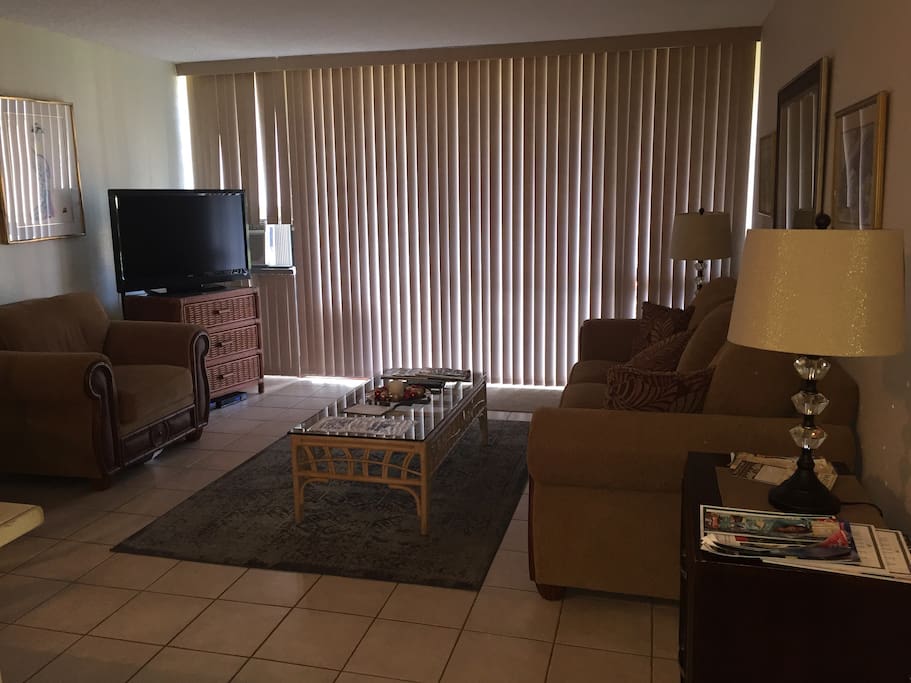 Living room with flat screen TV WiFi and cable. Directions for remotes on coffee table