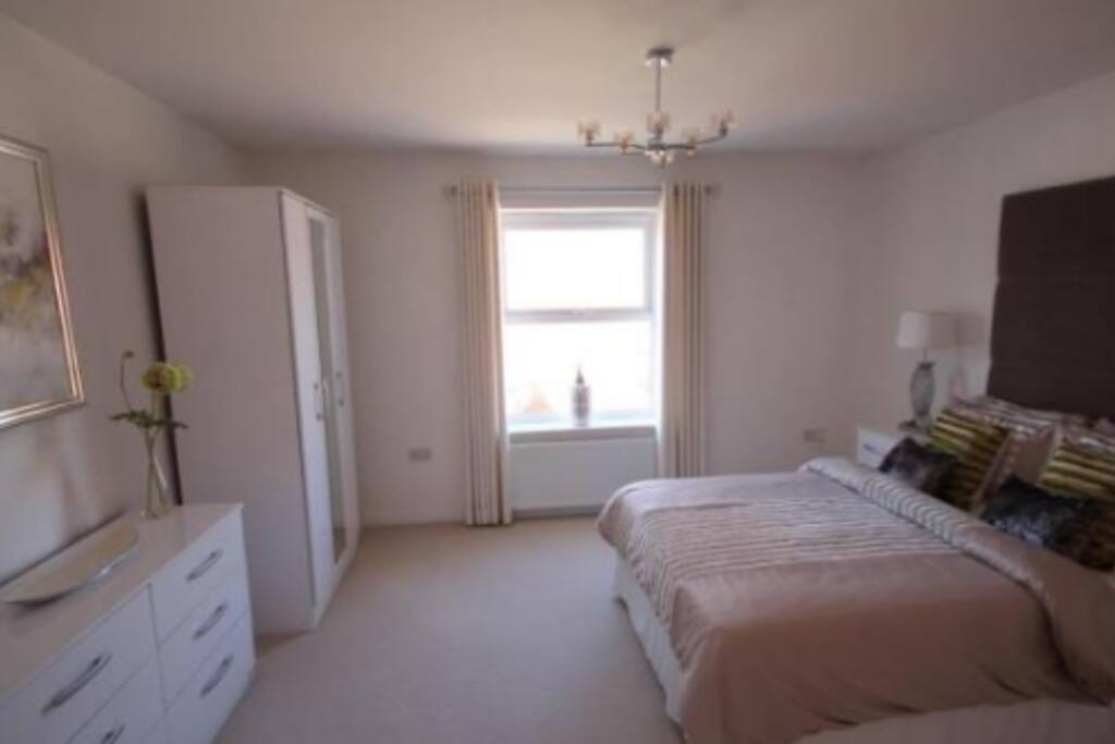 Bedroom 2. Has garden view. Large double bed with wardrobe.