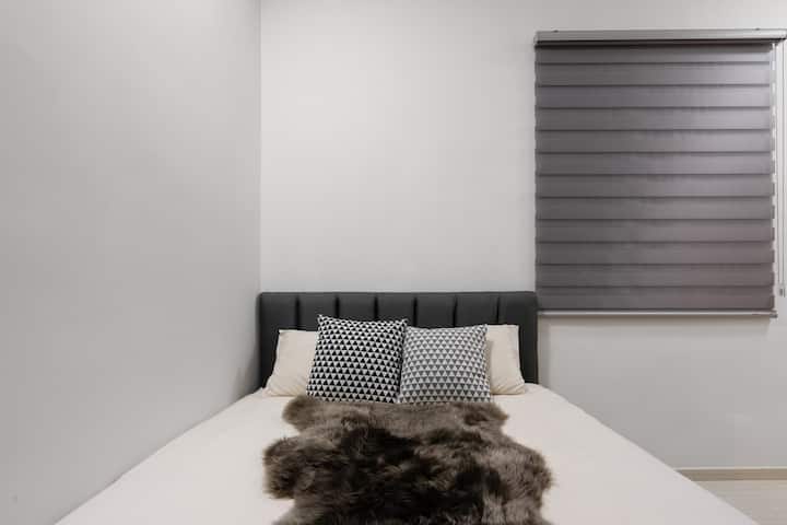 Bedroom queen bed with Zebra Blinds