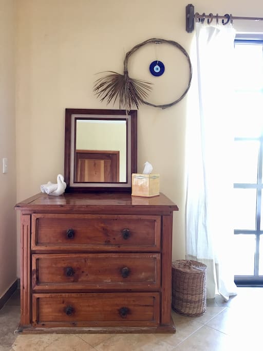 Cabinet located in MAUDE’S suite housing beach towels, extra bath towels, blanket, and an empty drawer for guests to use.