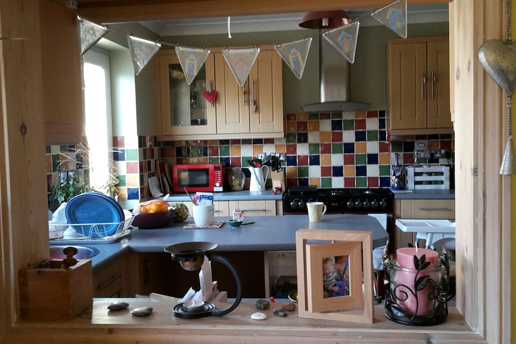 Family kitchen through hatch from dining room