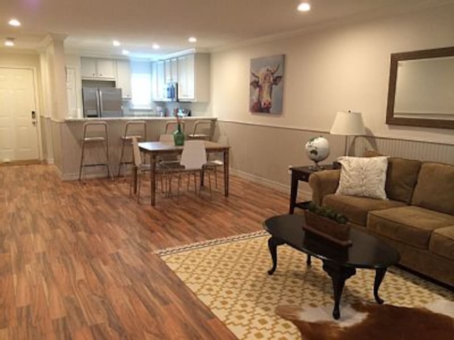 Open living space with direct access to carport and pool from townhouse entrances.