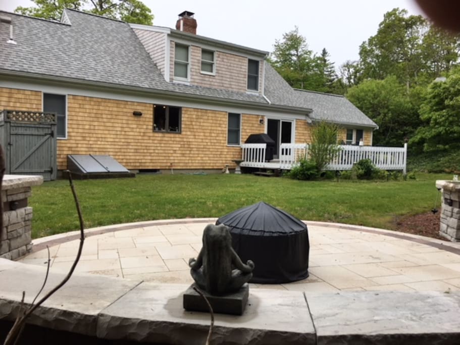 Private back yard with outdoor shower, large back porch, and new patio with sitting wall and fire pit area