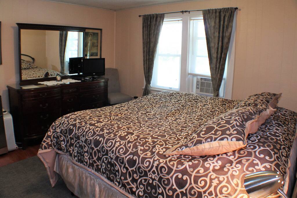 Large Dresser with T.V. The room also include a mini-fridge.