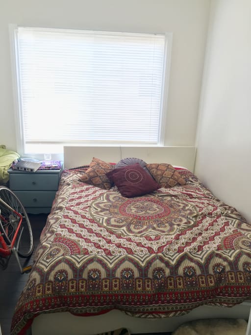 Bedroom: Queen size bed. Night stand. Many pillows. Large window and high ceiling fan for a cool breeze.