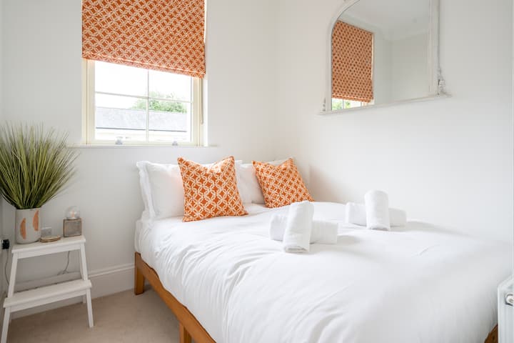 The second bedroom features a comfortable double bed and bedside table. 