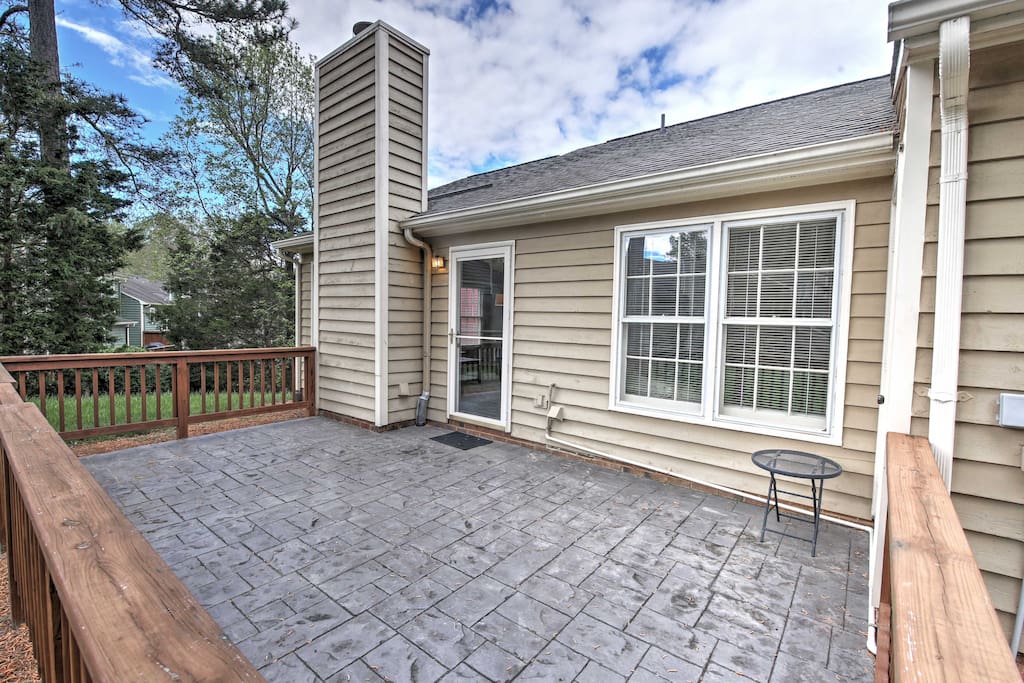 Lounge on the spacious private patio which looks out onto the grassy backyard.