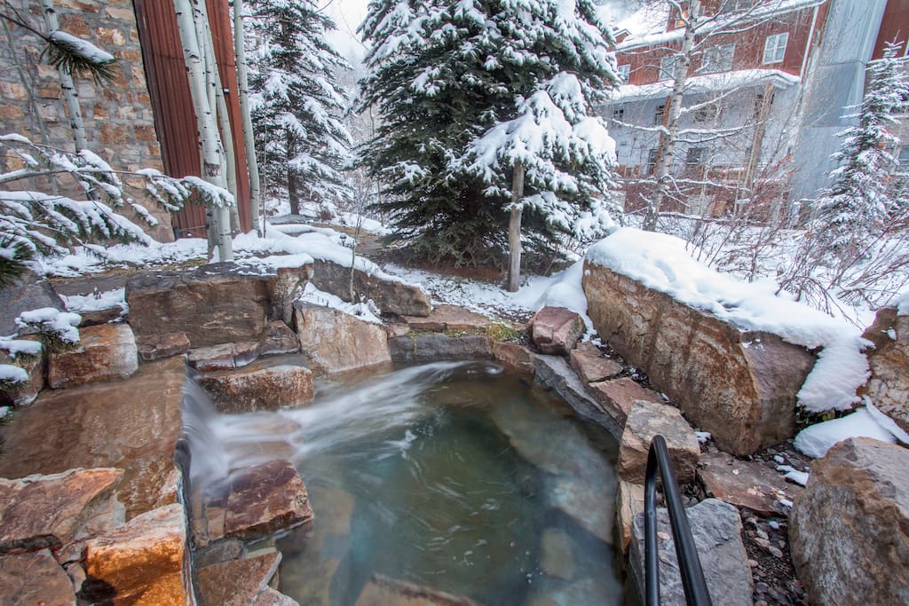 Soak your tired muscles after a long day of skiing in this stone hot tub right on the River Trail.