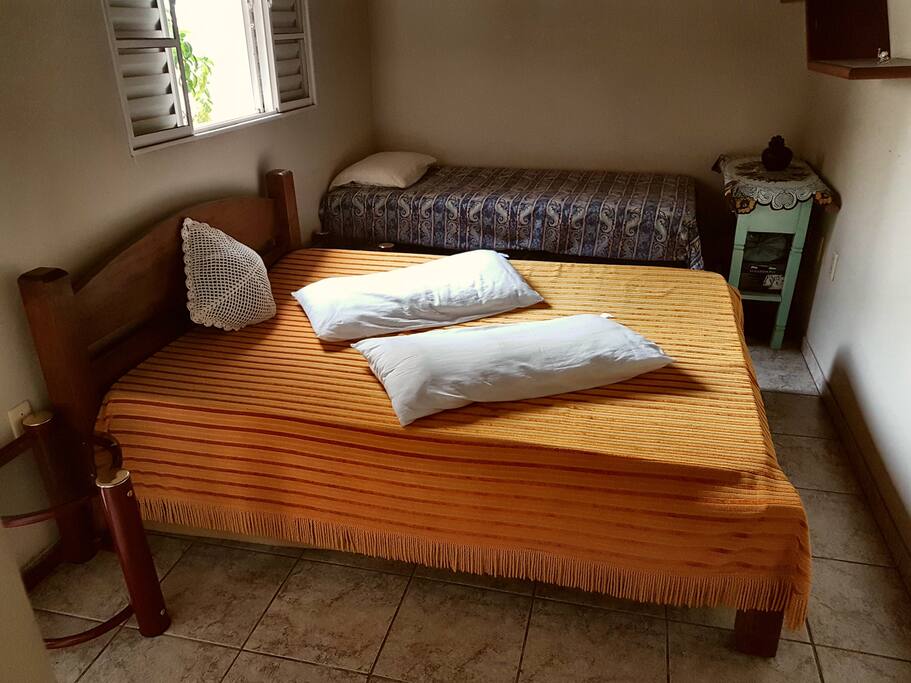 Quarto com cama de casal e solteiro