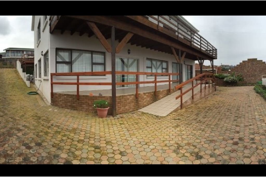 Front stoop with a ramp for wheelchair access. Private automated gate access by the left of the town house.