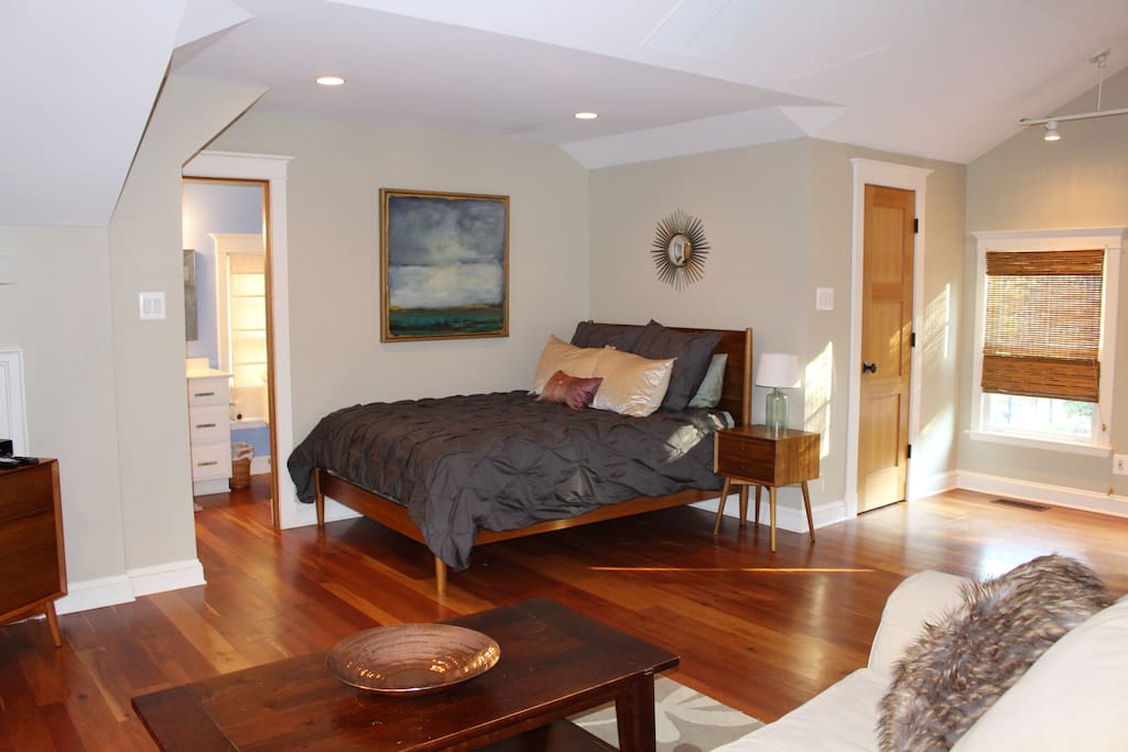 View of Queen size bed, closet and bathroom entries