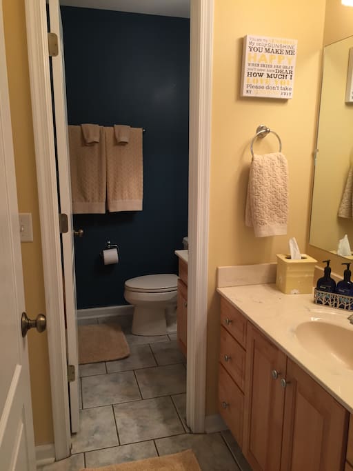 Double space bathroom area with full tub and two sink areas.