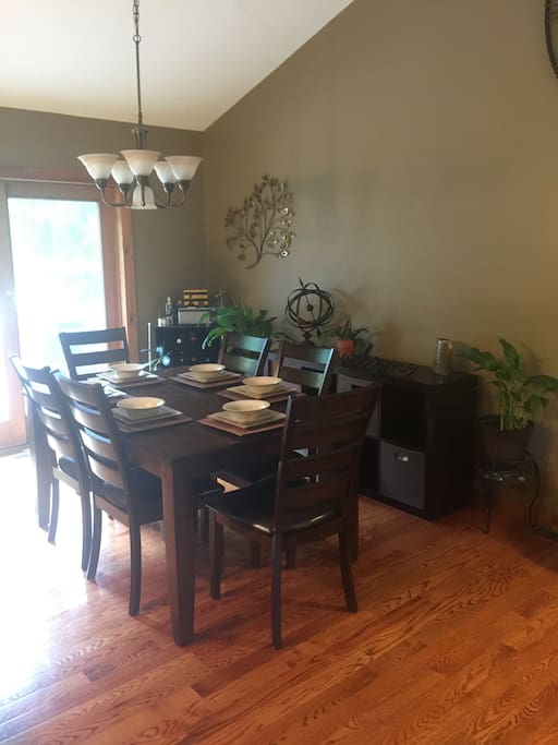 Open dining room with table that expands to fit 8 guests.