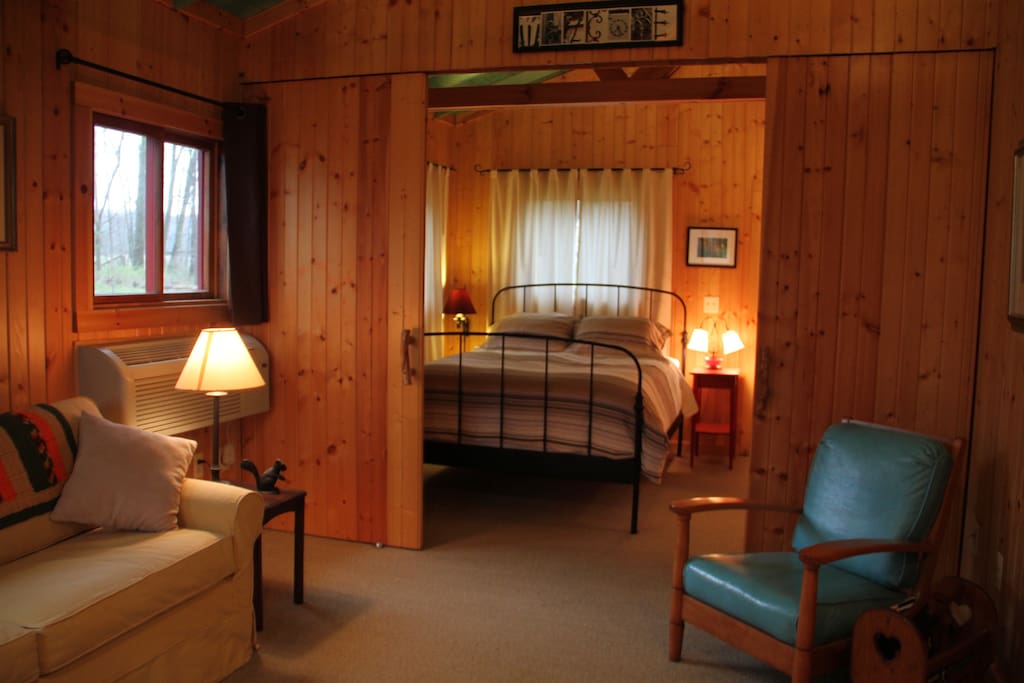 Queen bedroom as seen from the living room. Sliding doors to close it.