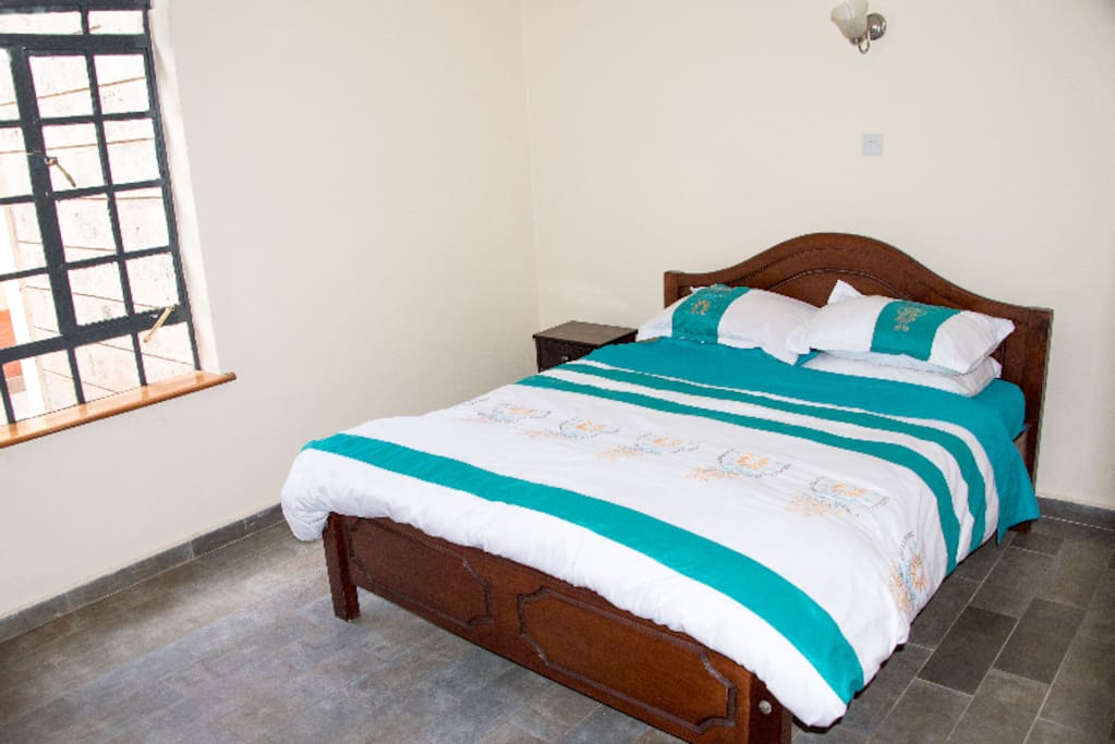 A spacious, clean bedroom with ample storage spaces.