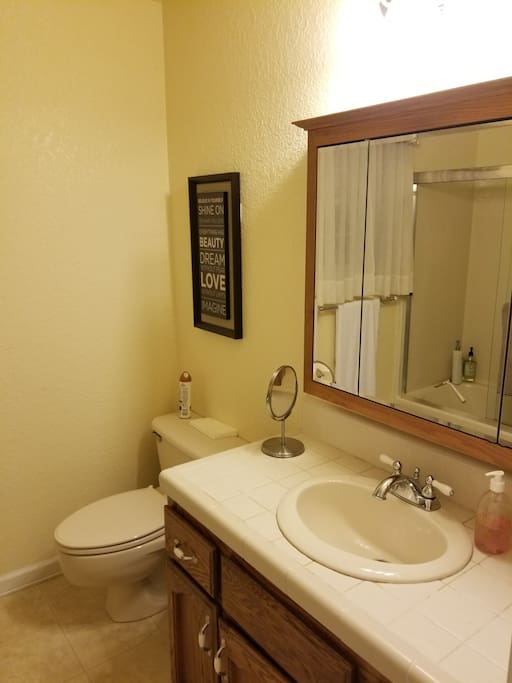 Cozy shared hall bathroom nearby with tub and shower.