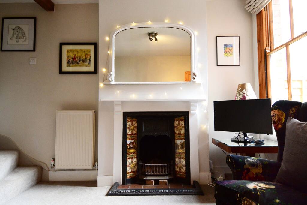 Main living room with easy chair and TV