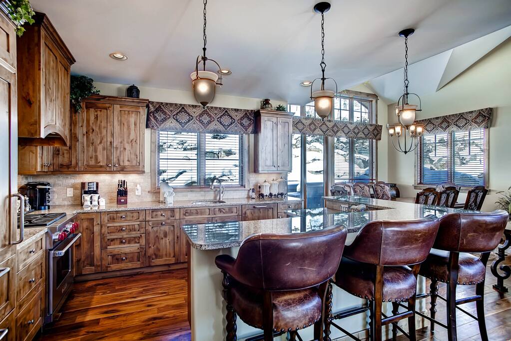 The kitchen features a breakfast bar and 3 stools