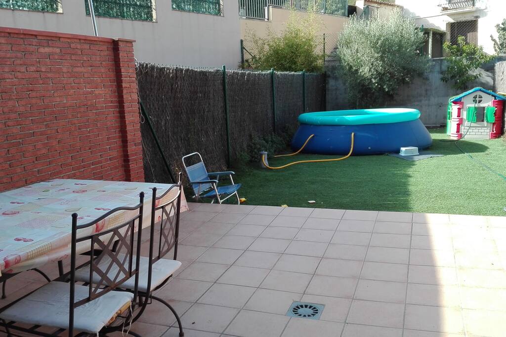 Ésta es la terraza posterior, con mesa para comer en el exterior.