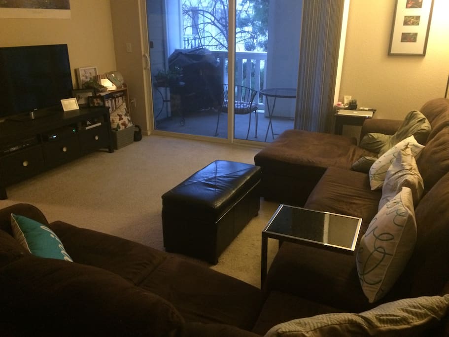 Living room with flat screen TV, cable, WiFi and balcony with gas grill