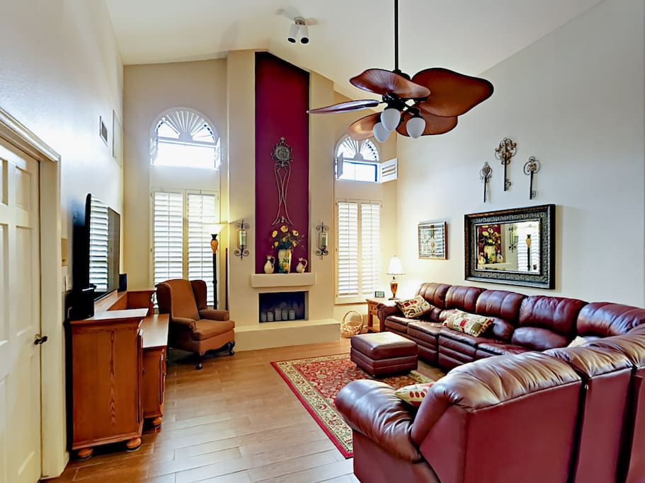 Soaring ceilings, comfy leather sofas, and tall windows in the living area.